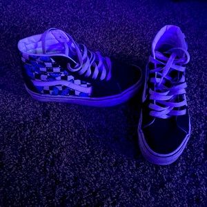 High top black and white checkered vans with blue butterfly’s on it